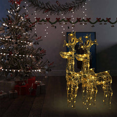 Two 39.4-inch lighted acrylic reindeer decorations glowing with warm white LEDs in a festive room.