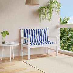 Two blue and white striped garden bench cushions tied to a white wooden bench on a balcony.