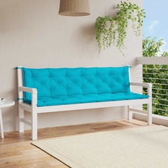 Turquoise outdoor bench cushions with water-repellent fabric and non-slip ties.