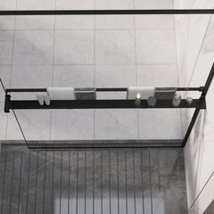 Black aluminum shower shelf mounted on glass panel, holding towels, shoes, and bottles.