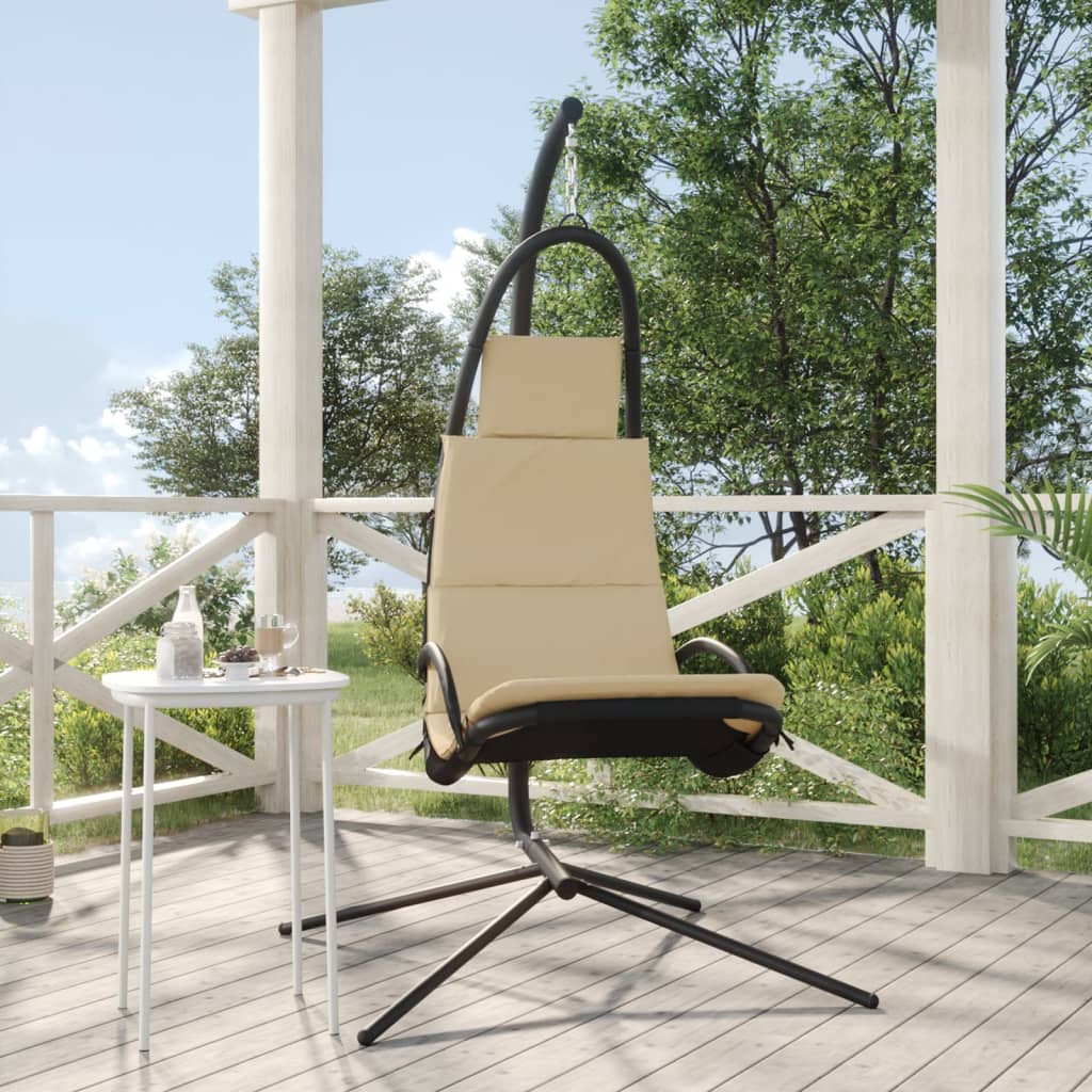 Cream garden swing chair with Oxford fabric cushions and black steel frame on a patio.