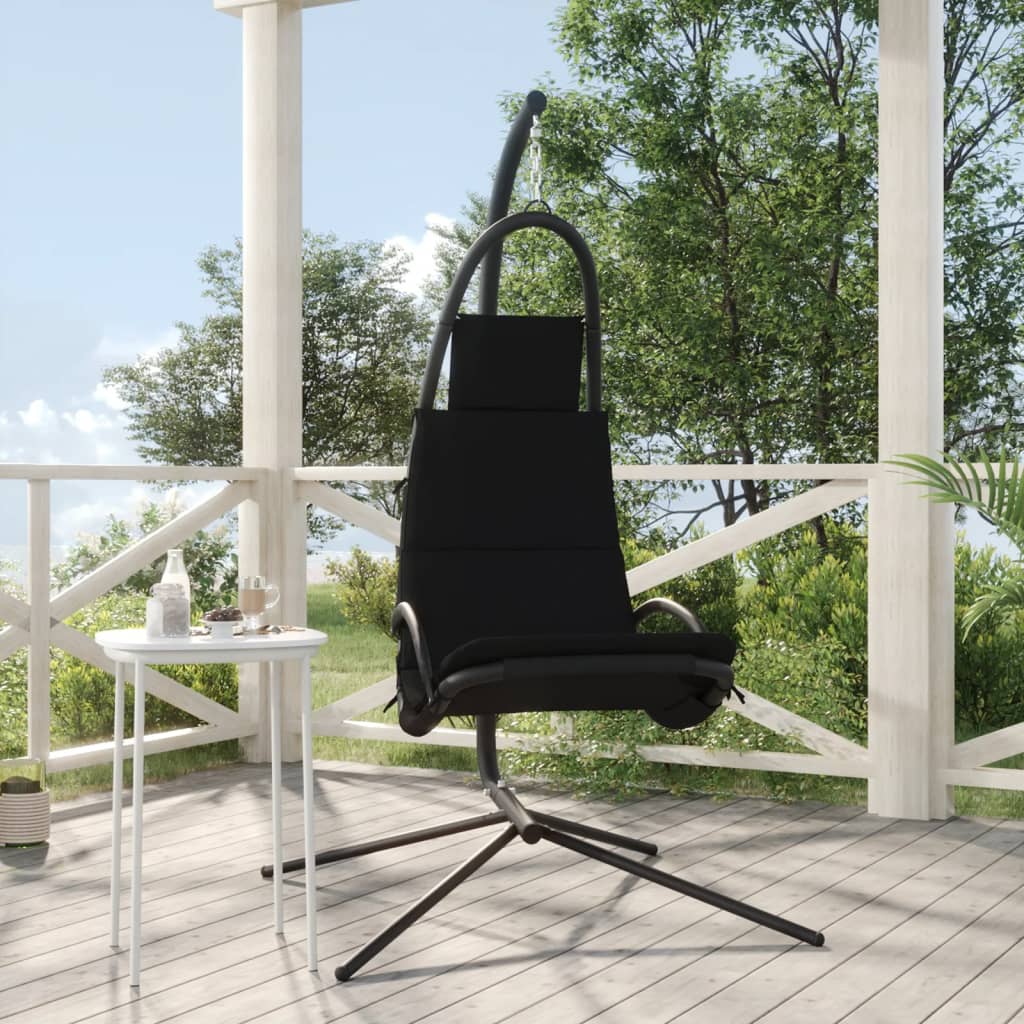 Black garden swing chair with Oxford fabric seat and steel frame on a patio.