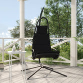 Black garden swing chair with Oxford fabric seat and steel frame on a patio.