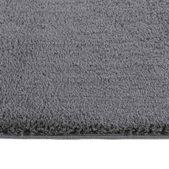 Anthracite shaggy polyester rug, 8'x10', with plush fibers and reinforced edges.