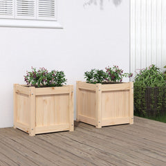 Two square solid pine wood planters with purple flowers on a deck.