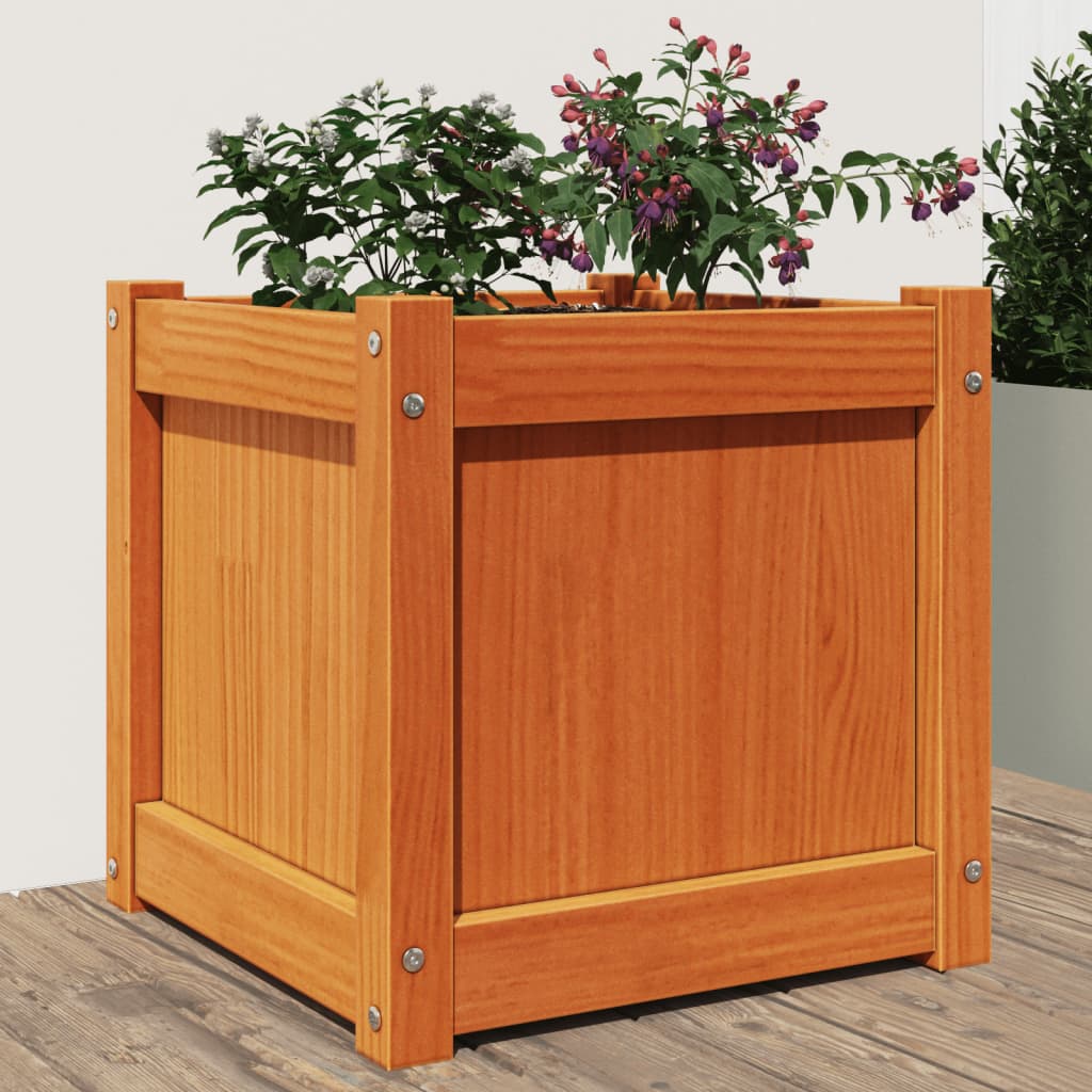 A square wax brown solid pine wood garden planter with flowering plants.