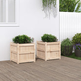 Two 19.7-inch square solid pine wood planters with boxwood shrubs on a wooden deck.