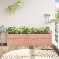 A rectangular solid Douglas wood garden planter, 70.9 x 19.7 x 19.7 inches, filled with lush green herbs and pink flowers on a sunny balcony.