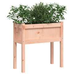 Wooden raised garden planter on legs, filled with green plants, made of solid Douglas fir.