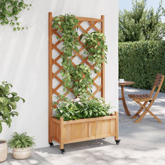 Brown fir wood planter with trellis and wheels holding green climbing plants against a wall.