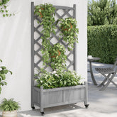 Gray solid fir wood planter with integrated trellis, supporting climbing plants and flowers, on wheels against a wall.
