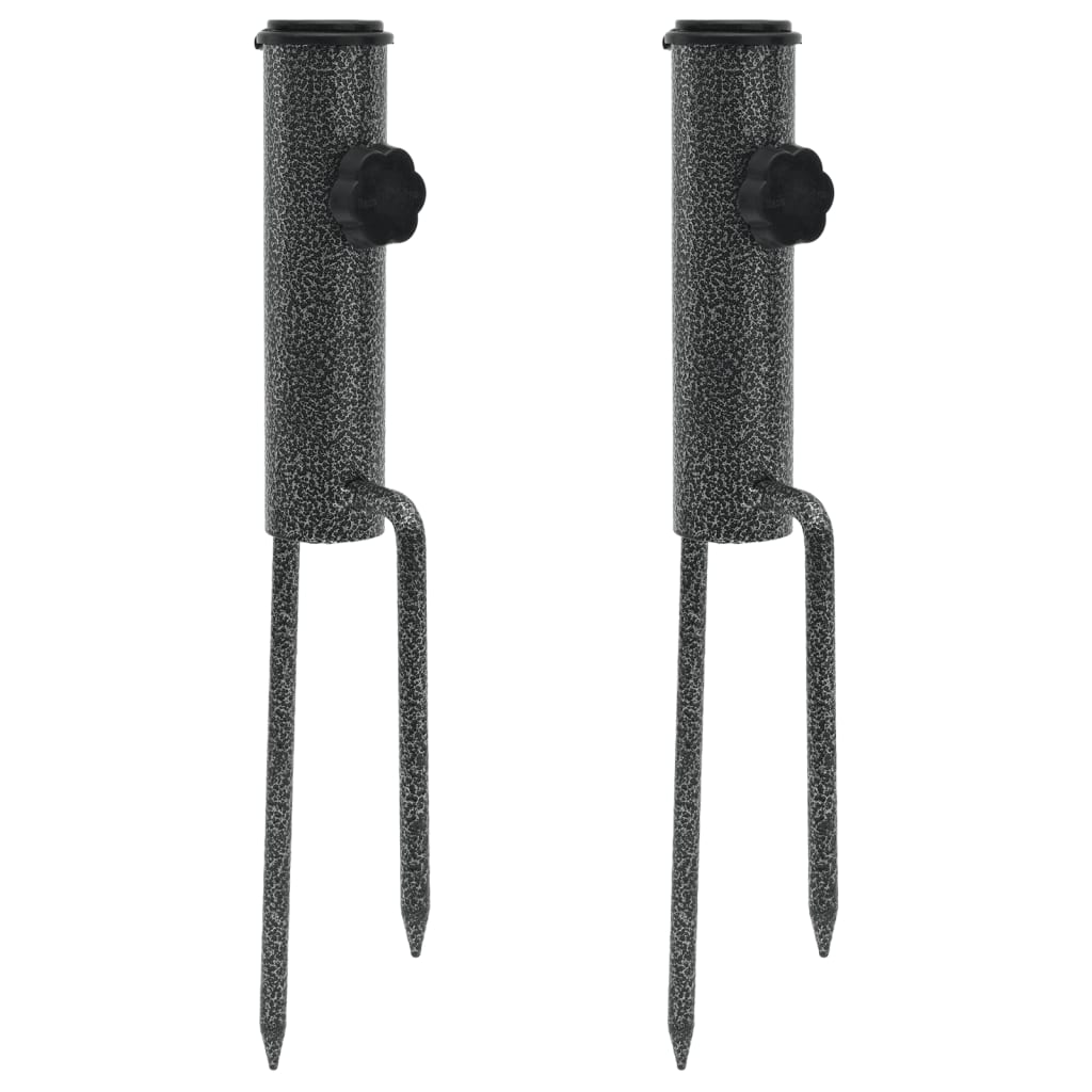 Two galvanized steel parasol stands with spikes for stability in outdoor settings.