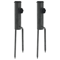 Two galvanized steel parasol stands with spikes for stability in outdoor settings.