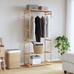 Bostome bamboo clothes rack with three shelves and side hooks for organized garment storage.