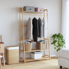 Bamboo clothes rack with hanging rod, three shelves, and side hooks in a light wood finish.