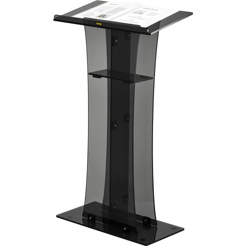 Clear acrylic pulpit with black accents, slanted reading surface, and storage shelf on a 47-inch stand.