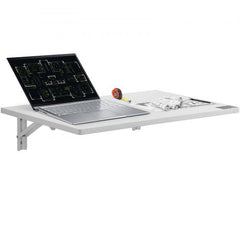 White wall-mounted folding table 23.62x15.75in with laptop, blueprints, and tape measure on top.