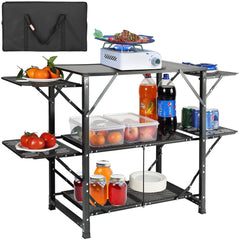 Folding aluminum camping kitchen table with shelves, side tables, and carry bag.