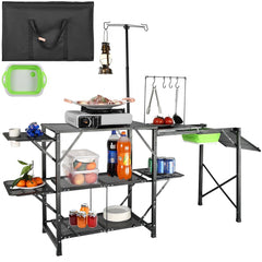 Folding camping kitchen table with aluminum top, side tables, shelves, and a detachable sink.