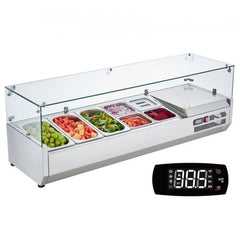 Refrigerated stainless steel condiment prep station with glass guard and assorted vegetable pans.