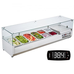 Bostome countertop refrigerated condiment prep station with stainless steel pans and glass guard.