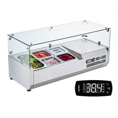 Countertop refrigerated condiment prep station with glass guard and stainless steel pans.