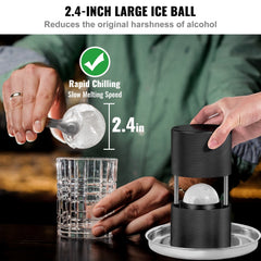 Black 2.4-inch aluminum ice ball press kit with tongs, shown pressing an ice sphere into a glass.