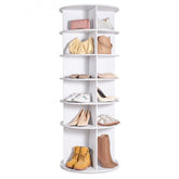 White 6-tier rotating shoe rack tower displaying shoes, boots, and purses on shelves.
