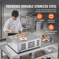 Refrigerated condiment prep station with 8 pans, stainless steel build, and chef serving veggies.