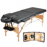 A black 28-inch wide portable massage table with folding wooden frame, adjustable height, face cradle, and armrests.