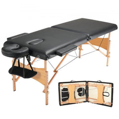 A black 28-inch wide portable massage table with folding wooden frame, adjustable height, face cradle, and armrests.
