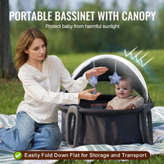 Portable baby bassinet with a folding design, canopy, and two toys for outdoor use.