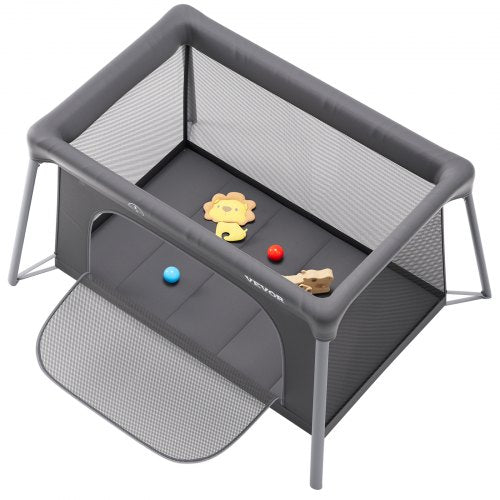 Dark gray folding baby travel crib play yard with zipper gate and breathable mesh sides.