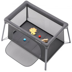 Dark gray folding baby travel crib play yard with zipper gate and breathable mesh sides.