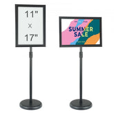 Adjustable pedestal sign holder for 11x17 signs, featuring a rotatable frame and weighted base.