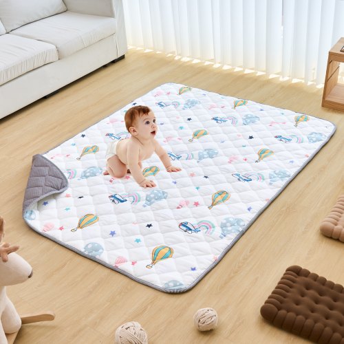 Soft baby play mat with colorful hot air balloon and cloud patterns on a white quilted surface