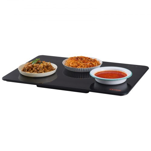 Black electric warming tray with tempered glass surface and adjustable temperature control.
