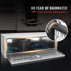 Silver aluminum diamond plate underbody truck box, 48x17x18 inches, open with tools inside and 360-degree rubber seal.