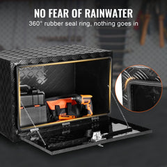 Black aluminum underbody truck tool box, 36x24x24 inches, open with tools inside and 360-degree rubber seal detail.