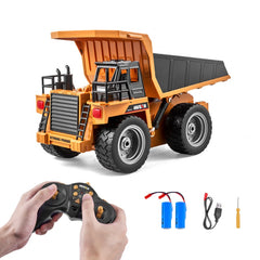 Orange 1:18 scale RC dump truck with open bed, 4WD tires, black remote control, batteries, USB cable, and screwdriver.