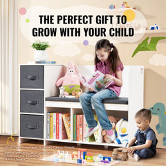 White kids reading nook bench with bookshelf cubbies, drawers, cushion, and toddler sitting on it reading.