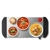 Stainless steel warming tray with a 21.54 x 10.35-inch surface and precise temperature control.