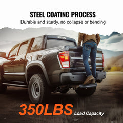 A person steps on a black steel hitch step attached to the rear of a dark pickup truck in a mountainous area.