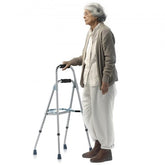 Silver-haired senior woman using a one-arm folding hemi walker with adjustable height.