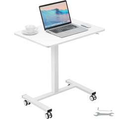White mobile standing desk with adjustable height, laptop, mouse, cup, and caster wheels.