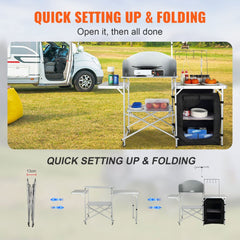 Folding aluminum camping kitchen table with storage compartments and side hooks for organization.