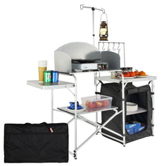 Bostome folding camping kitchen table with aluminum frame, storage compartments, and side hooks.