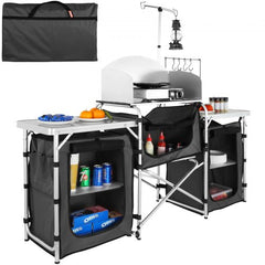 Folding aluminum camping kitchen table in black with storage shelves, bag, and lamp pole.