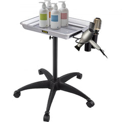 Adjustable height stainless steel salon tray on wheels with holders for bottles, hairdryer, and brush.