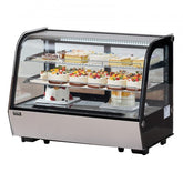 Curved glass refrigerated bakery display case with 2 tiers of cakes and pastries.